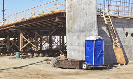 a lineup of sanitized porta potties on a busy work site